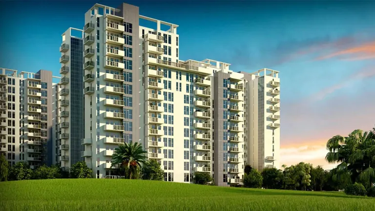 Ireo The Corridors residential towers above a green lawn at sunset, artist's impression