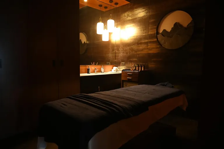 Krisumi Waterfall Residences spa treatment room with massage bed, actual photo
