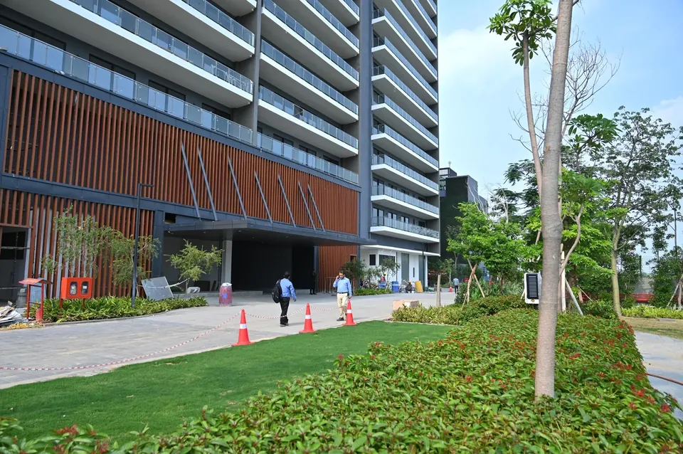 Krisumi Waterfall Residences tower facade above the landscaped front lawn, actual photo