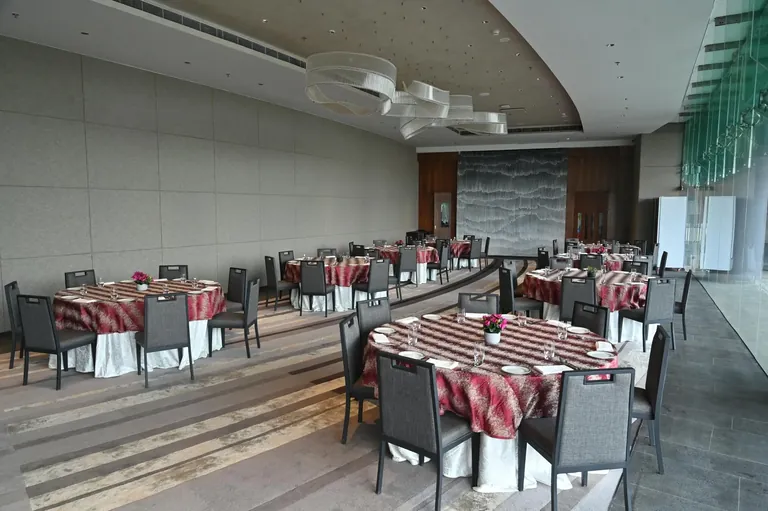 Krisumi Waterfall Residences banquet hall laid out with round dining tables, actual photo
