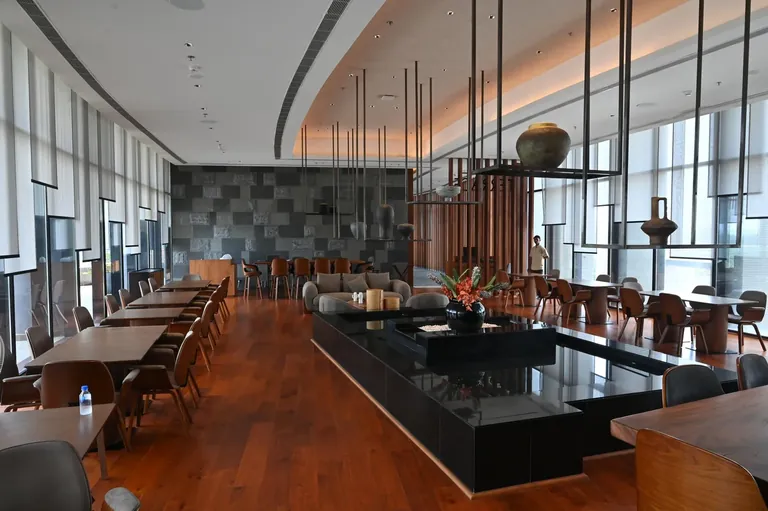Krisumi Waterfall Residences clubhouse restaurant with long dining counter, actual photo