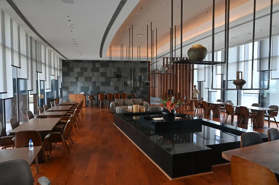 Krisumi Waterfall Residences clubhouse restaurant with long dining counter, actual photo