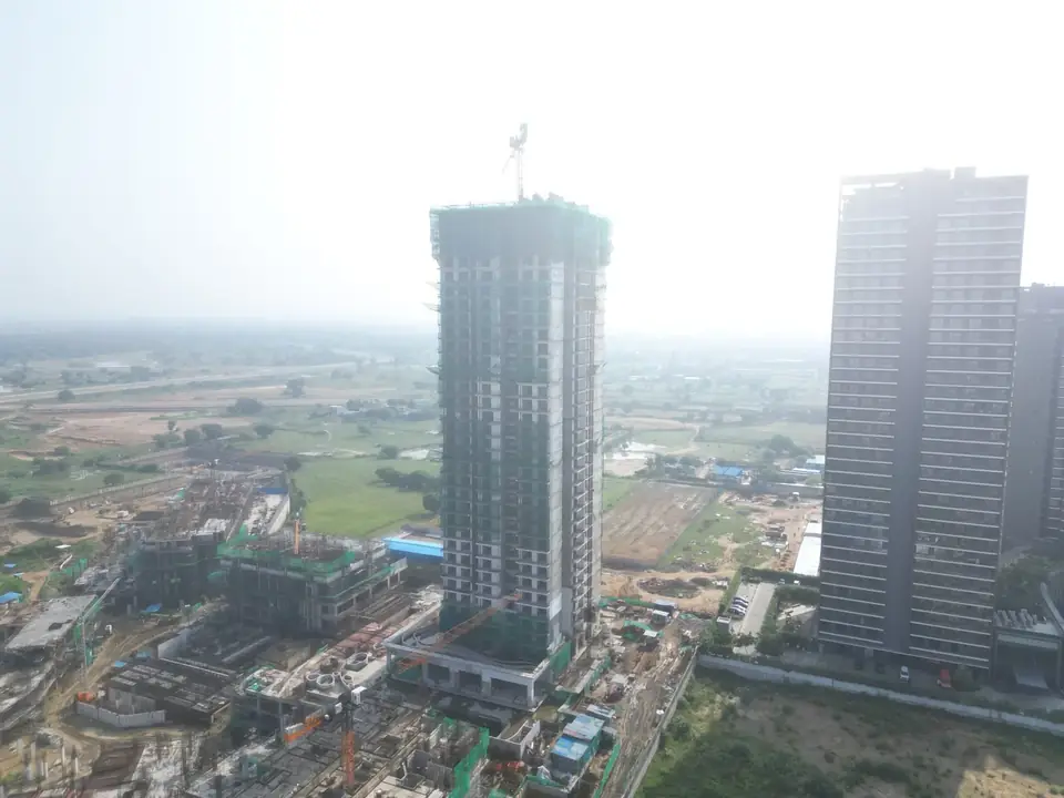 Krisumi Waterfall Suites tower under construction, drone photo, September 2026