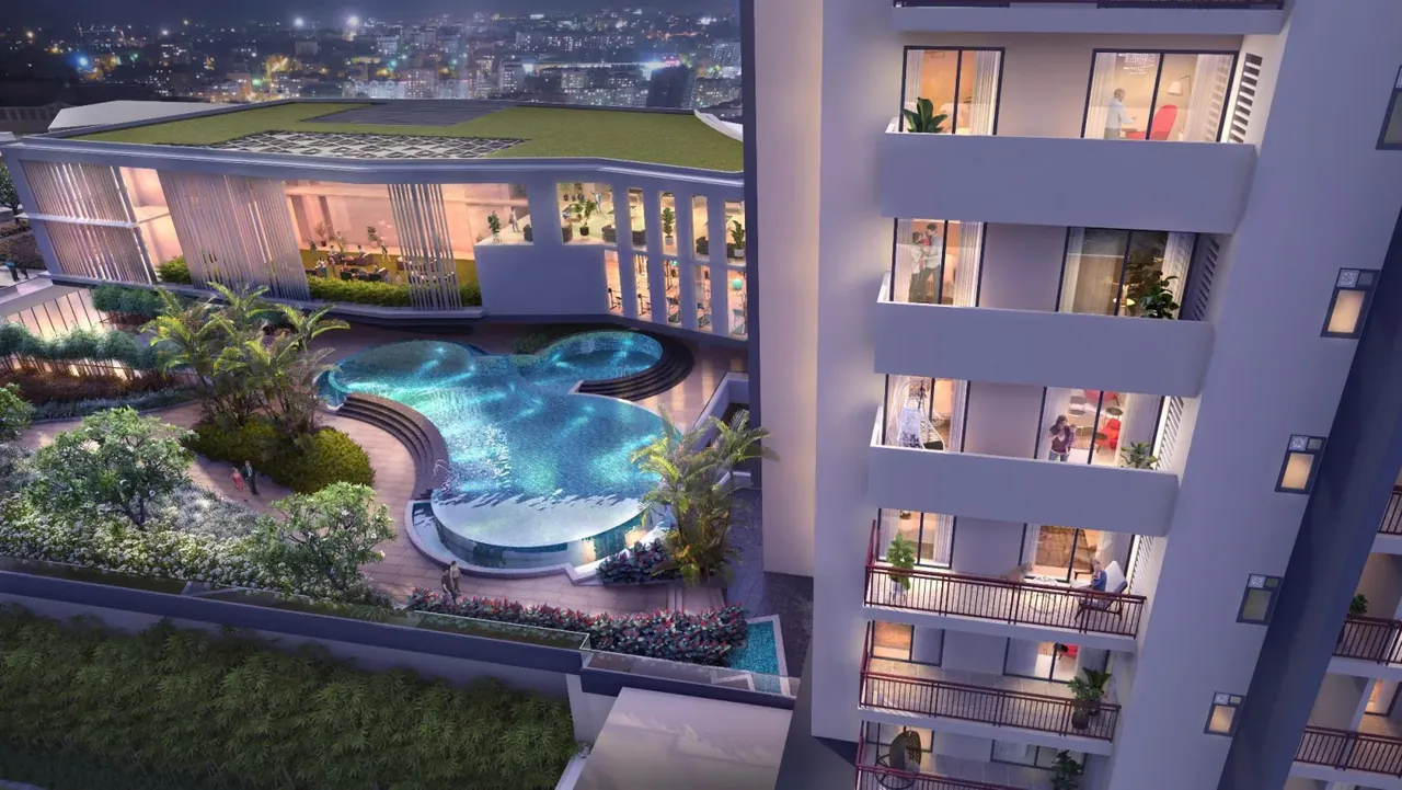 M3M Heights raised pool deck lit at night beside the residential tower, artist's impression