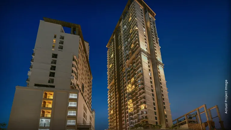 M3M Heights two completed towers photographed from below at dusk