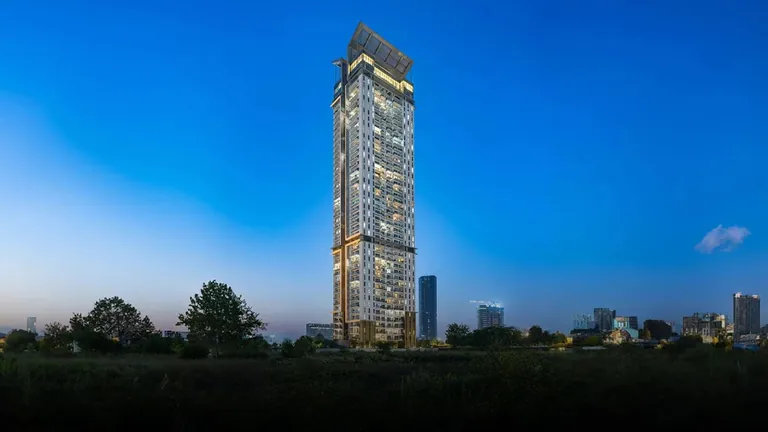M3M Latitude single tower lit up at dusk above the surrounding greenery, artist's impression