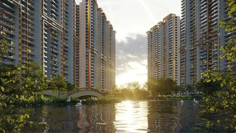 M3M Mansion towers reflected in the lake, with a footbridge over the water, artist's impression