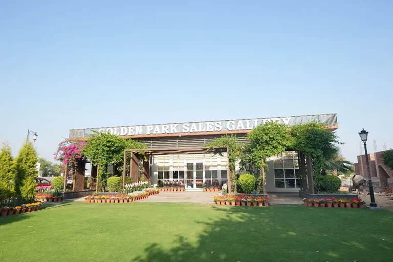 Meffier Golden Park Golden Park sales gallery with a lawn in front