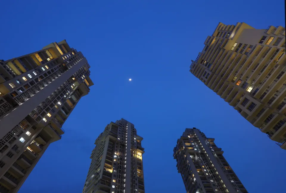 Pioneer Araya towers lit at night, seen from below