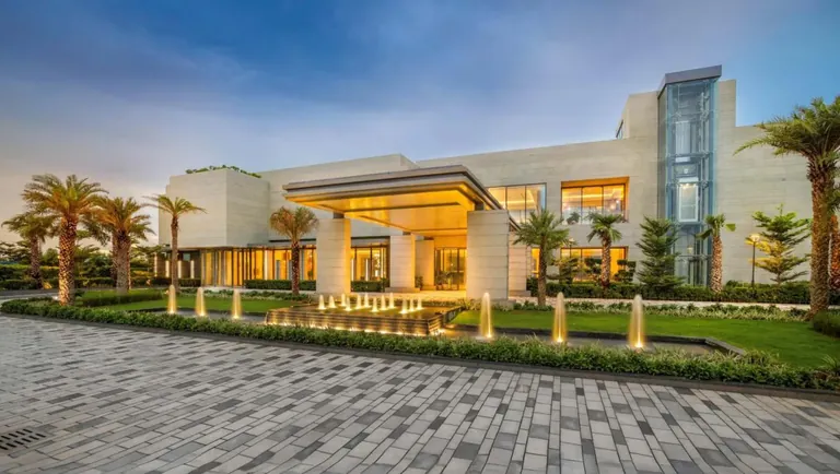 Puri Diplomatic Greens clubhouse building at dusk