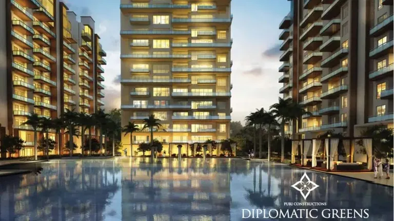 Puri Diplomatic Greens pool and clubhouse lit at night below the towers