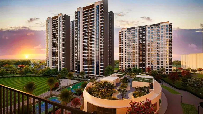 Puri Diplomatic Greens towers at sunset with the clubhouse roof garden in front