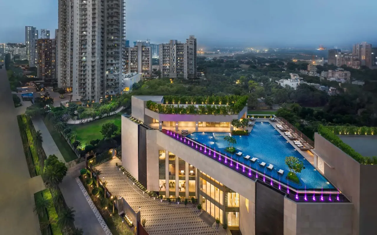 Puri Diplomatic Greens rooftop pool of the club with the towers around