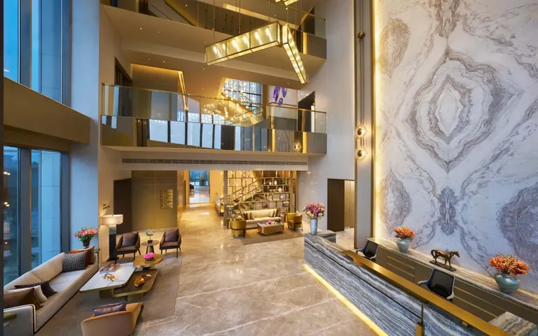 Puri Diplomatic Residences double-height lobby with a marble feature wall, artist's impression