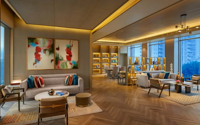 Puri Diplomatic Residences club lounge with sofas and a reading wall, artist's impression