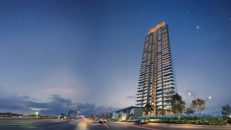 Signature Global Cloverdale SPR iconic tower lit up at night from the approach road, artist's impression