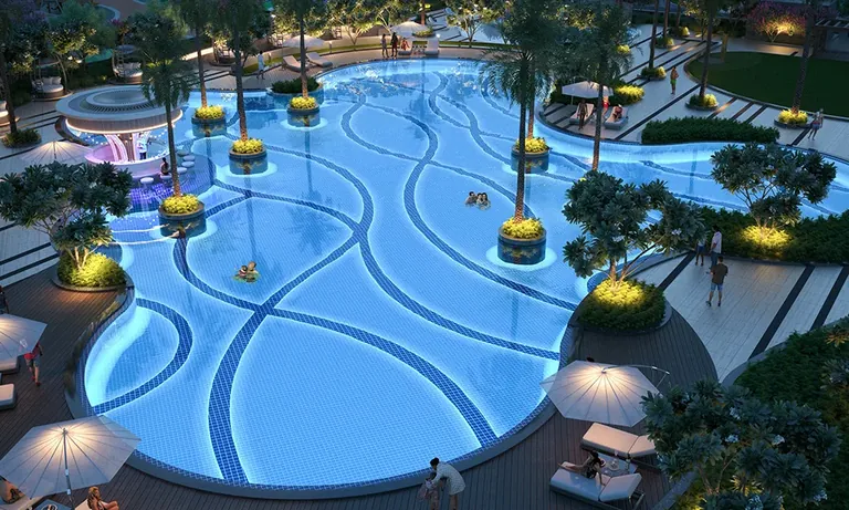Smartworld One DXP lagoon pool lit at night with the towers behind, artist's impression
