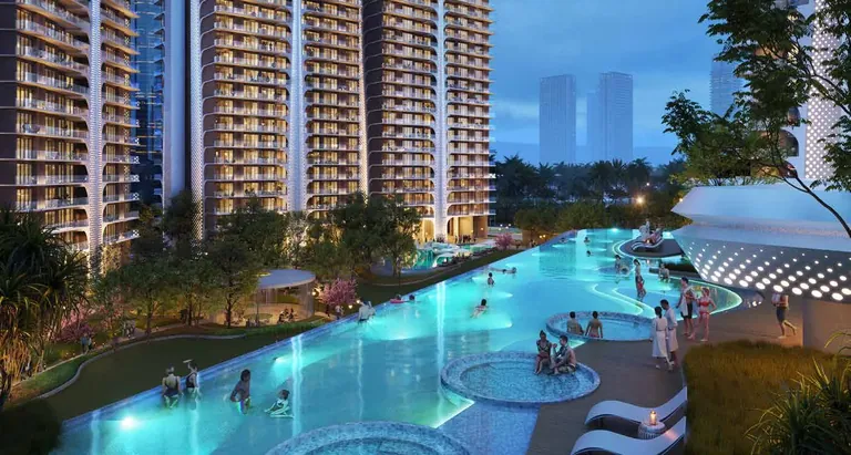 Smartworld The Edition lagoon-style swimming pool lit at dusk below the towers, artist's impression