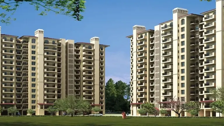 Tulip Orange two residential tower blocks behind a green lawn, Sector 70 Gurgaon, artist's impression